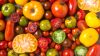 Close up of colorful tomatoes, some sliced, shot from above