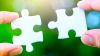 two hands person trying to connect couple Jigsaw paper white puzzle piece